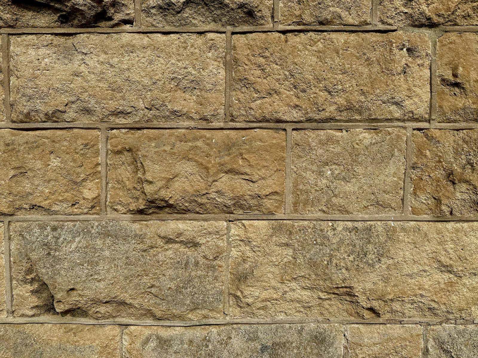 Close-up of a cut-stone wall in warm light