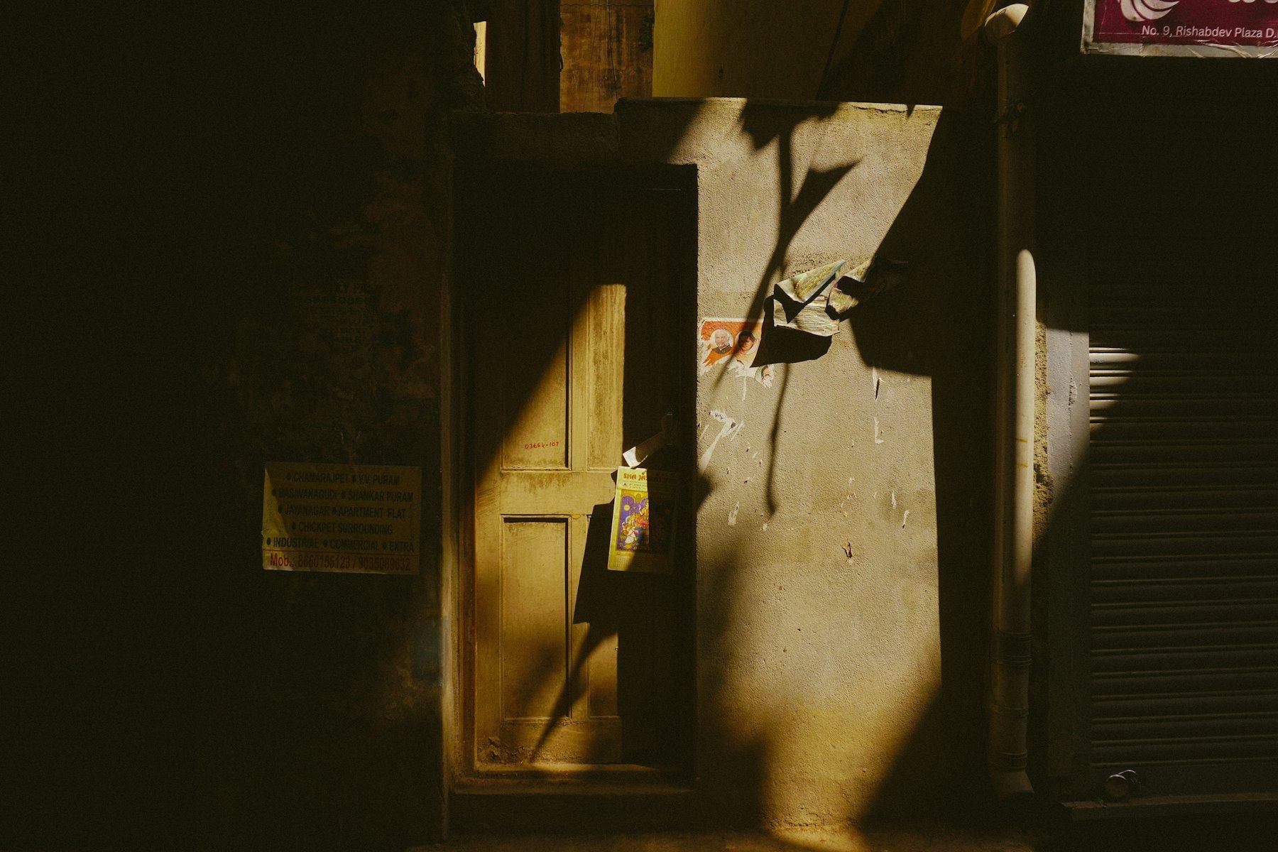 Afternoon sunlight falling through a doorway onto a textured wall