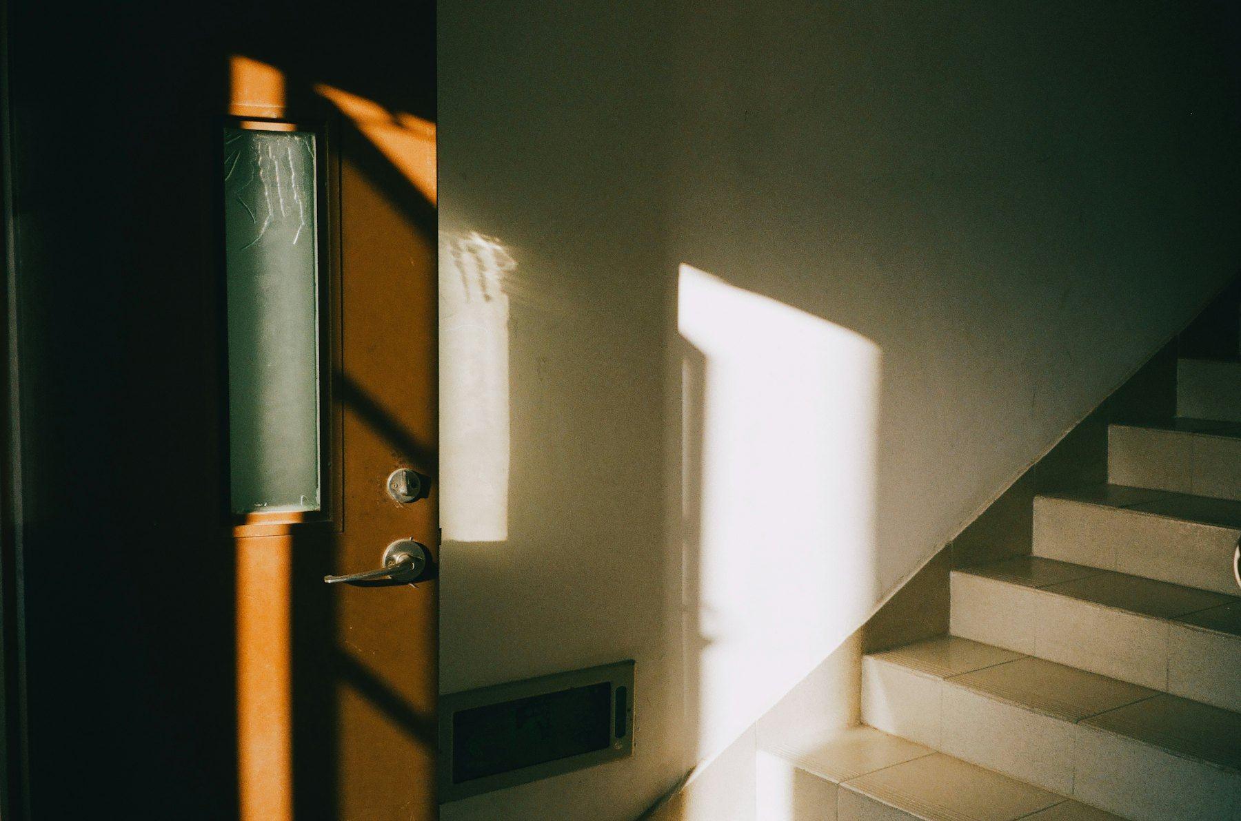 Sunlight through an open door onto a staircase